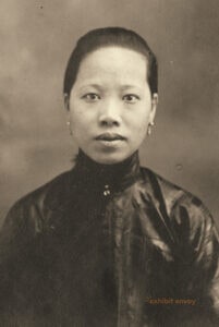 An Asian woman looks at the camera in an old photograph.